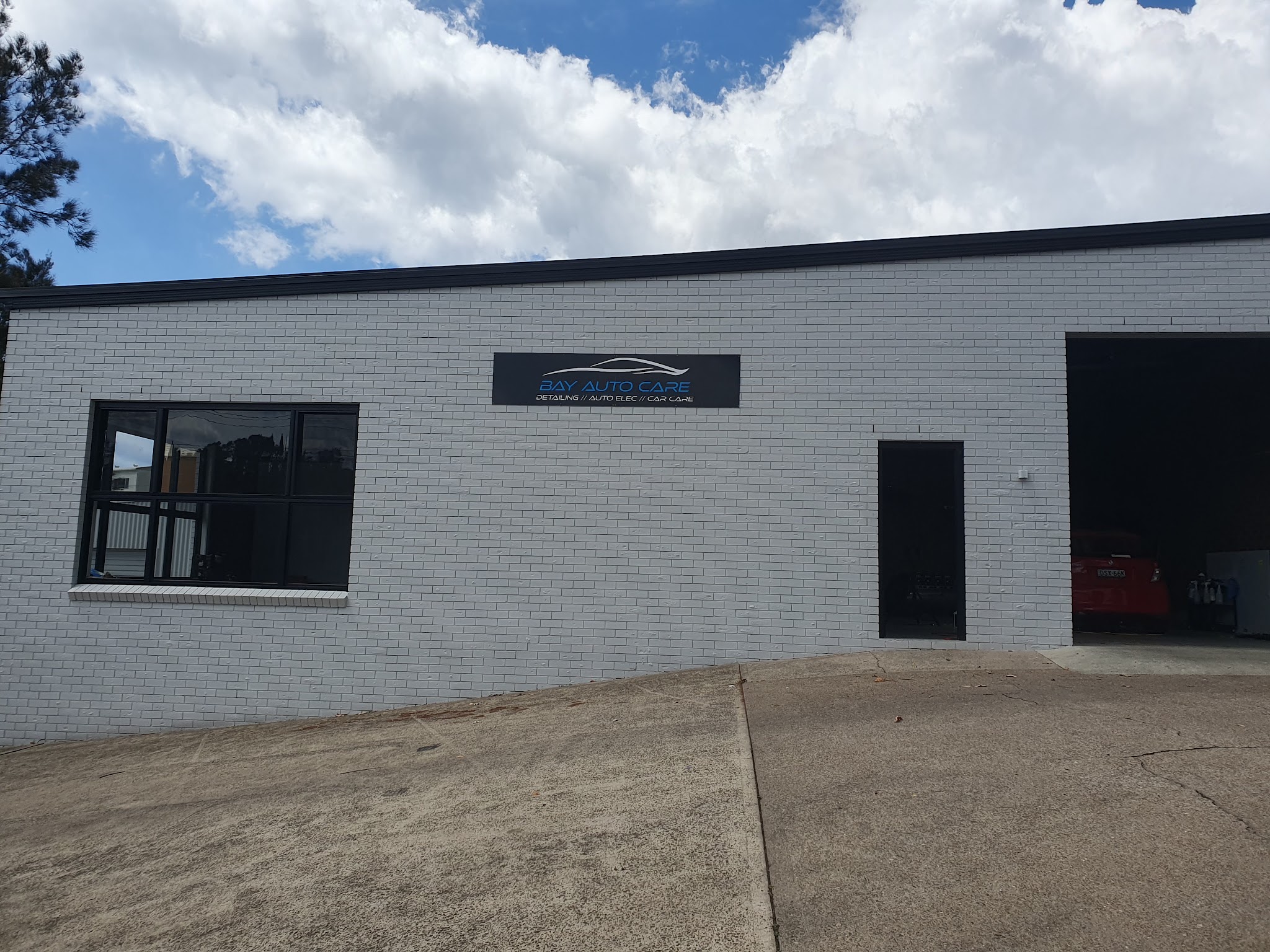 The Bay Auto Care workshop on Kylie Crescent, white brick with the business sign above the roller door