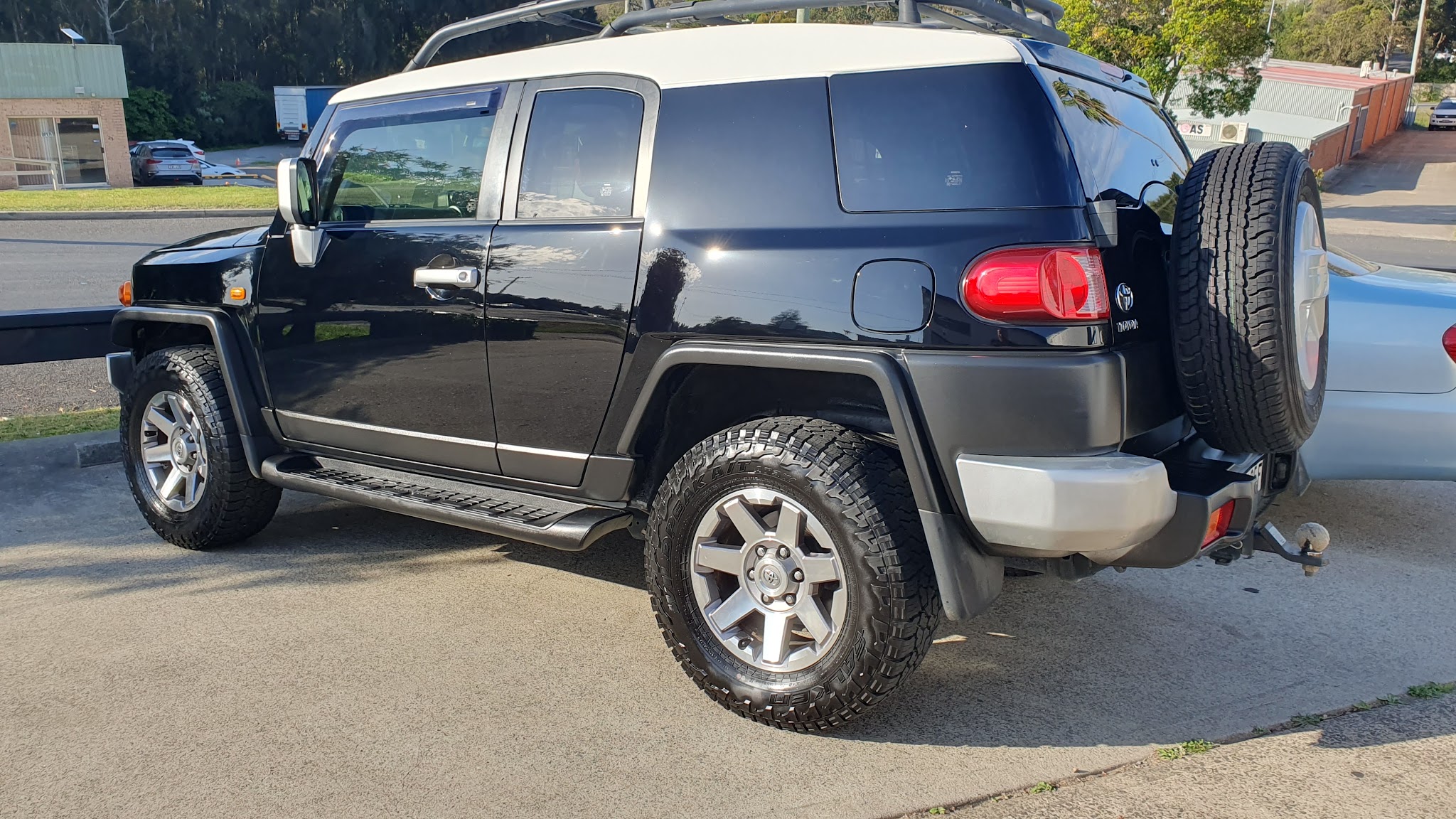 A black Toyota FJ Cruiser freshly detailed outside the workshop
